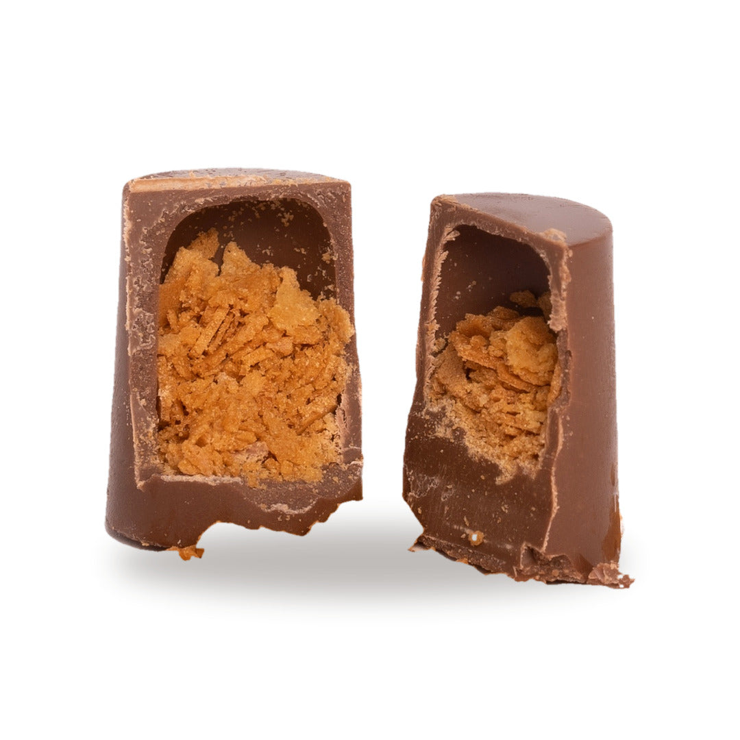 A milk chocolate Feuilletine broken open, showing the toasted crêpe inside