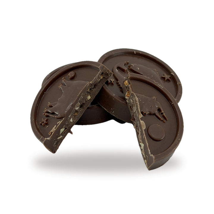 An Almond Hazelnut Horoscope cut open, showing the chopped almond and hazelnut praline inside