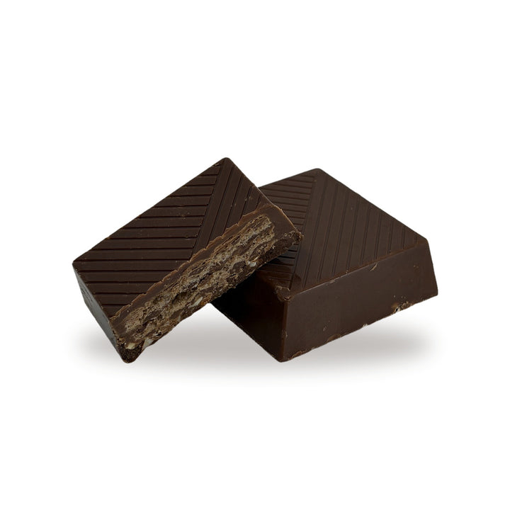 A Hazelnut Biscuit cut open, showing the layered wafer and hazelnut cream center inside the milk chocolate