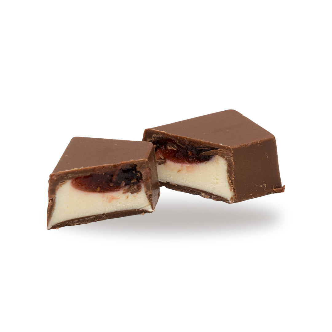 A milk chocolate Cheesecake broken open, showing the filling inside