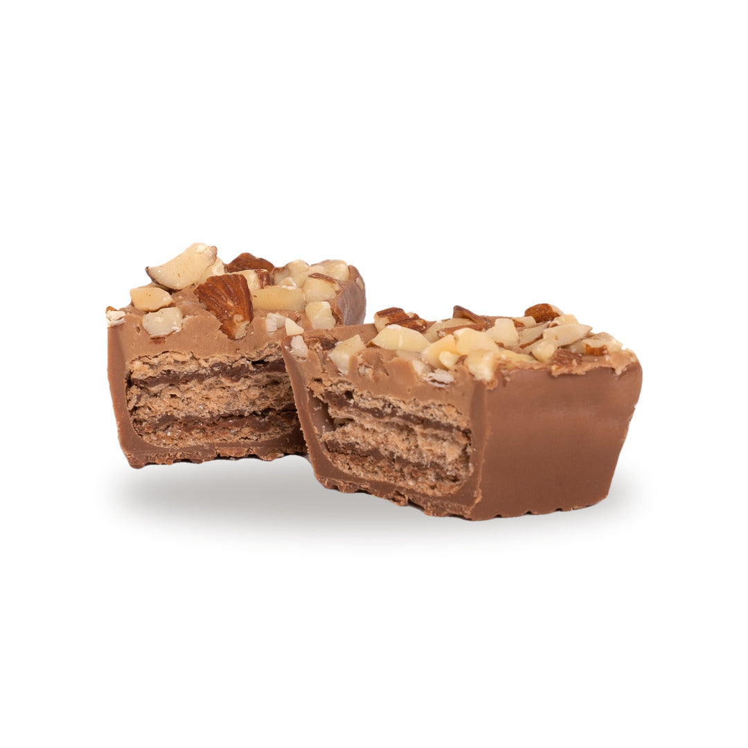 A milk chocolate Peanut Almond Praline broken open, showing the biscuit inside