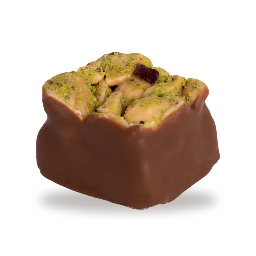 A whole Madlouka — a dark chocolate square with cashew