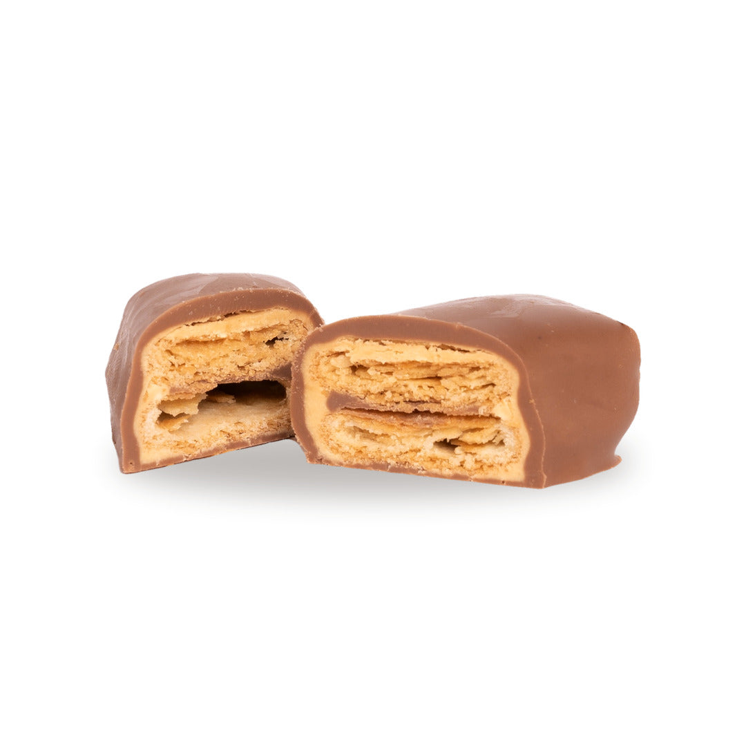 A milk chocolate Mille-Feuille broken open, showing the layered pastry and crêpe inside