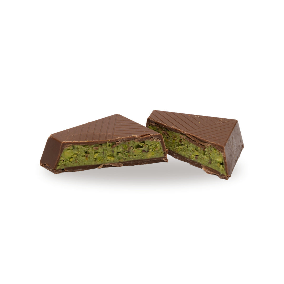 A milk chocolate Pistachio Paste broken open, showing the filling inside