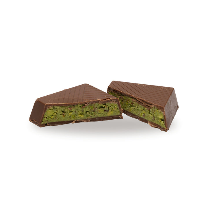 A milk chocolate Pistachio Paste broken open, showing the filling inside