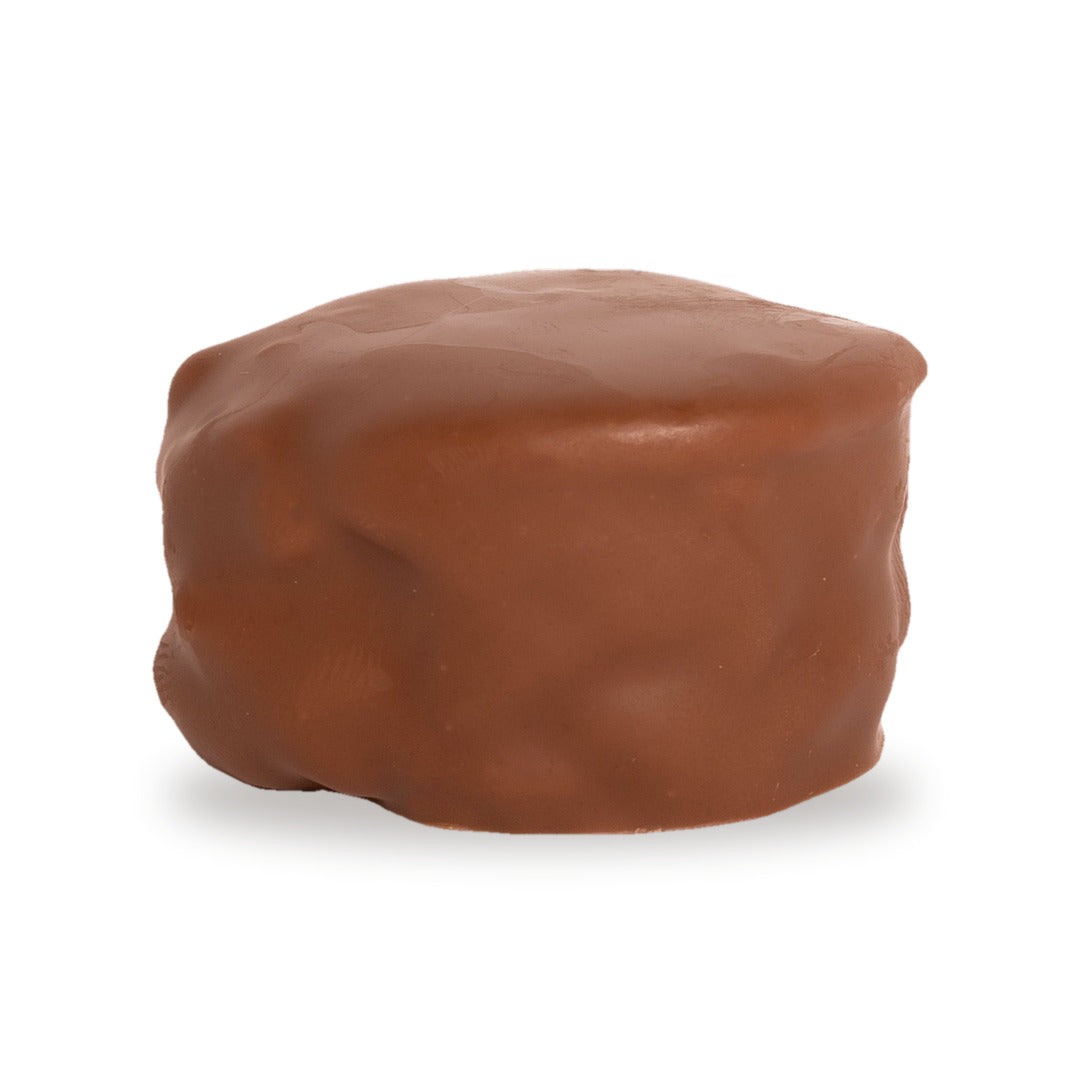 A whole Snayniyeh — a milk chocolate round with cashew and pistachio