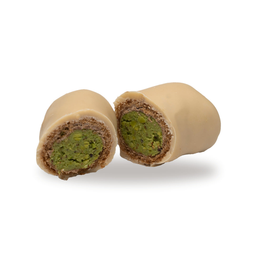 A chocolate Pistachio Biscuit Roll broken open, showing the cream inside