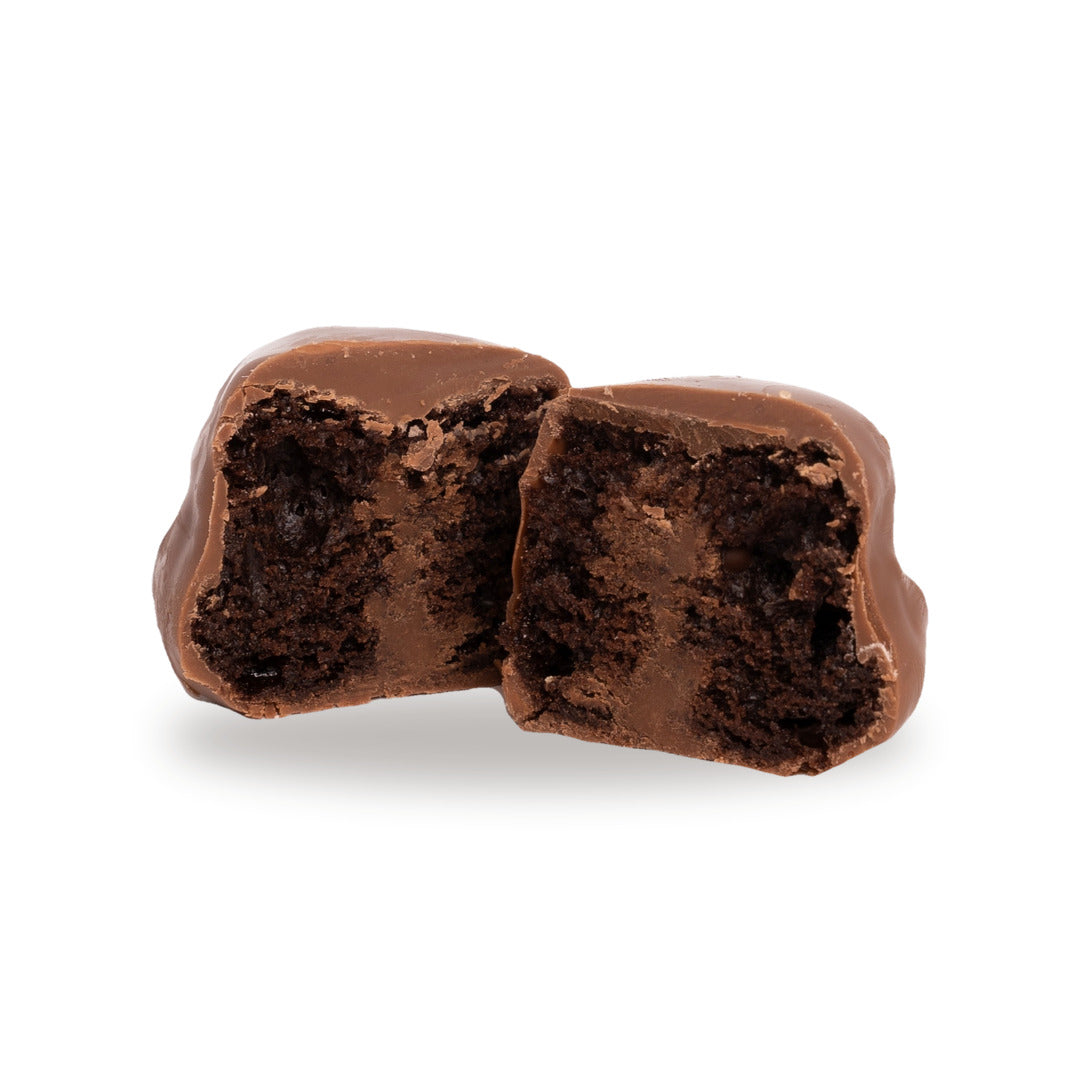 A milk chocolate Cupcake broken open, showing the brownie and cream inside