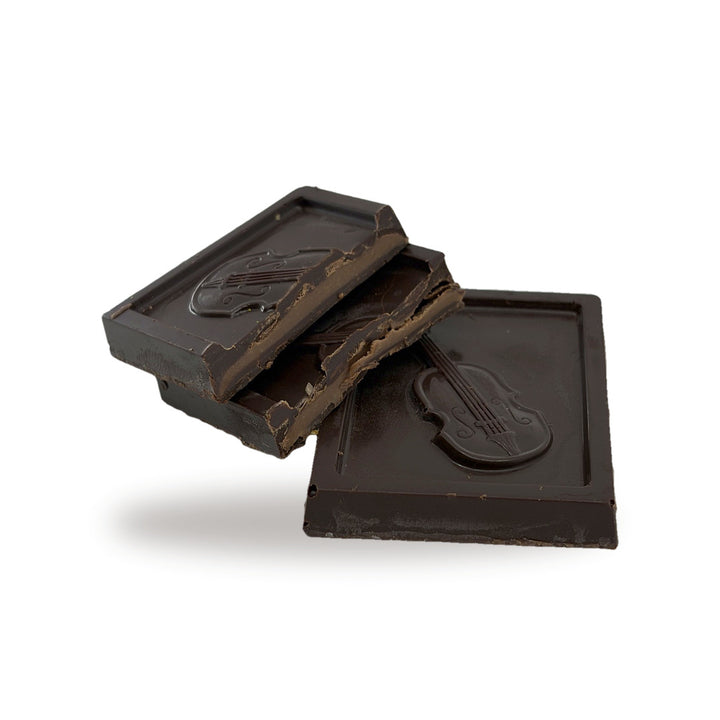 A Praline (Dark) cut open, showing the smooth praline layer inside the dark chocolate