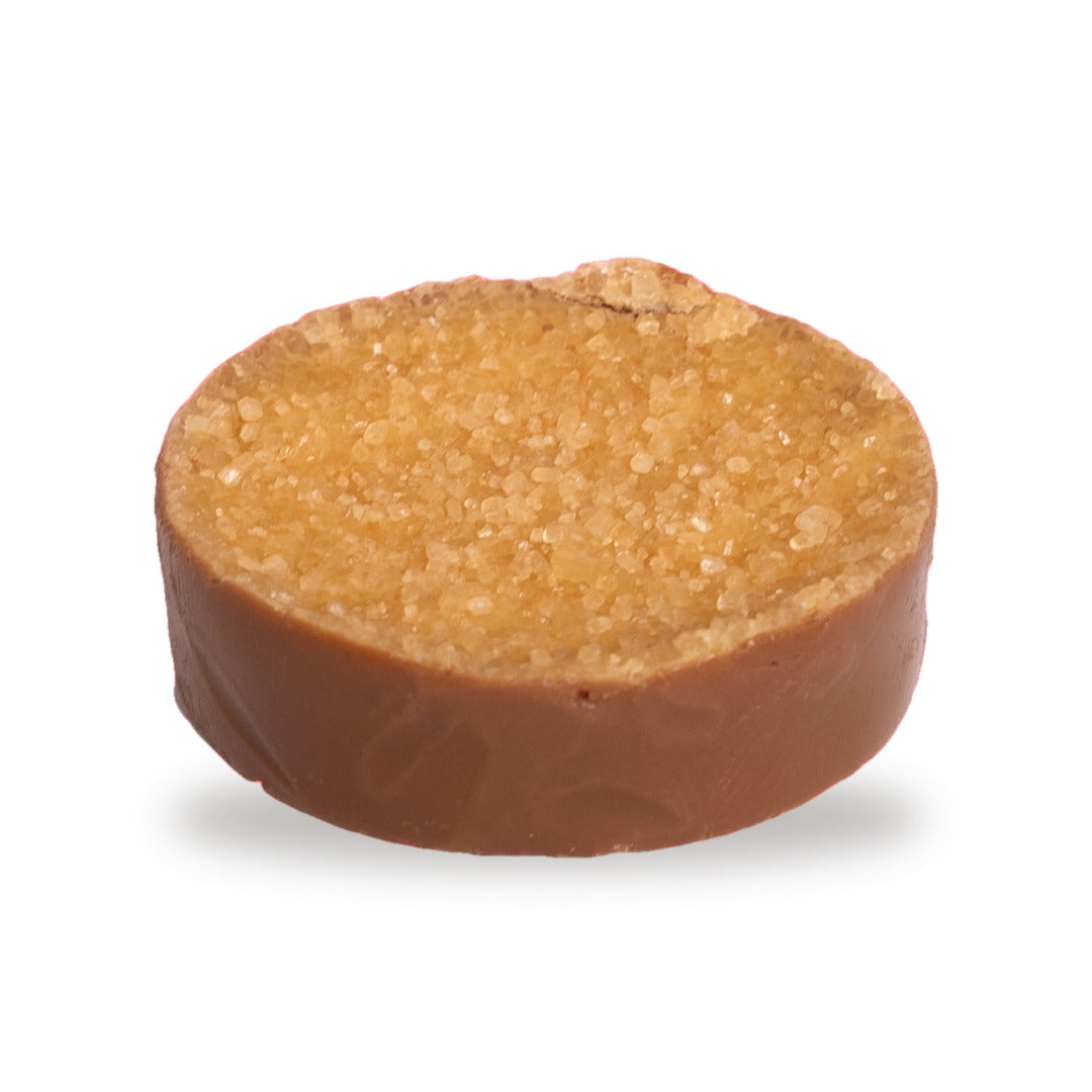 A whole Crème Brûlée — a round milk chocolate with a textured golden top
