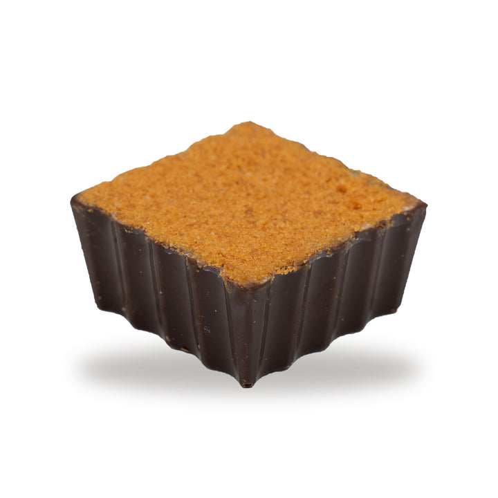 A whole Kenefe Caramel Biscuit — a dark chocolate piece