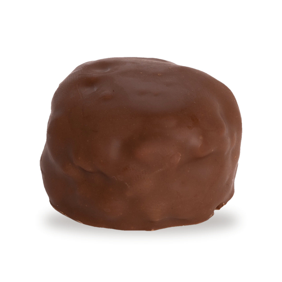 A whole Snayniyeh — a dark chocolate round with cashew and pistachio