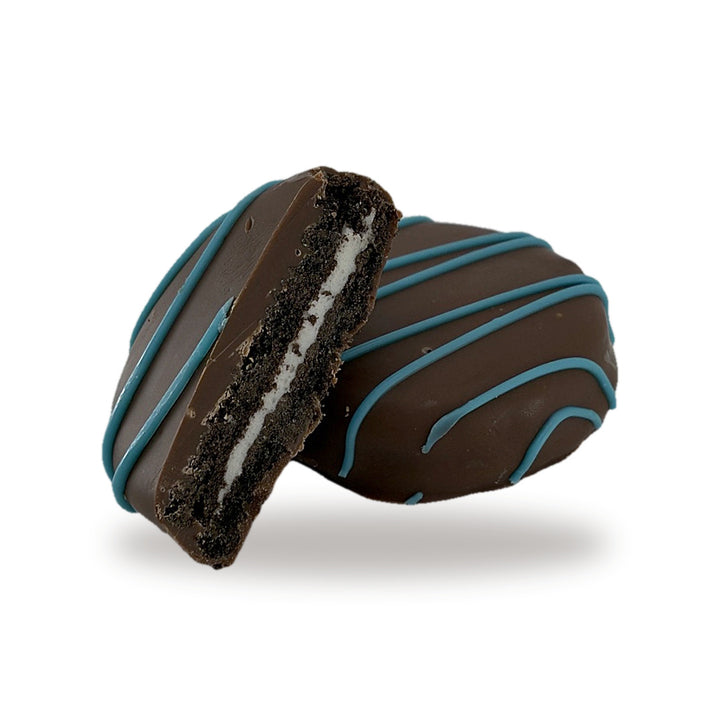 A Cocoa Cookie Blue cut open, showing the cocoa cookie and cream filling inside the milk chocolate shell
