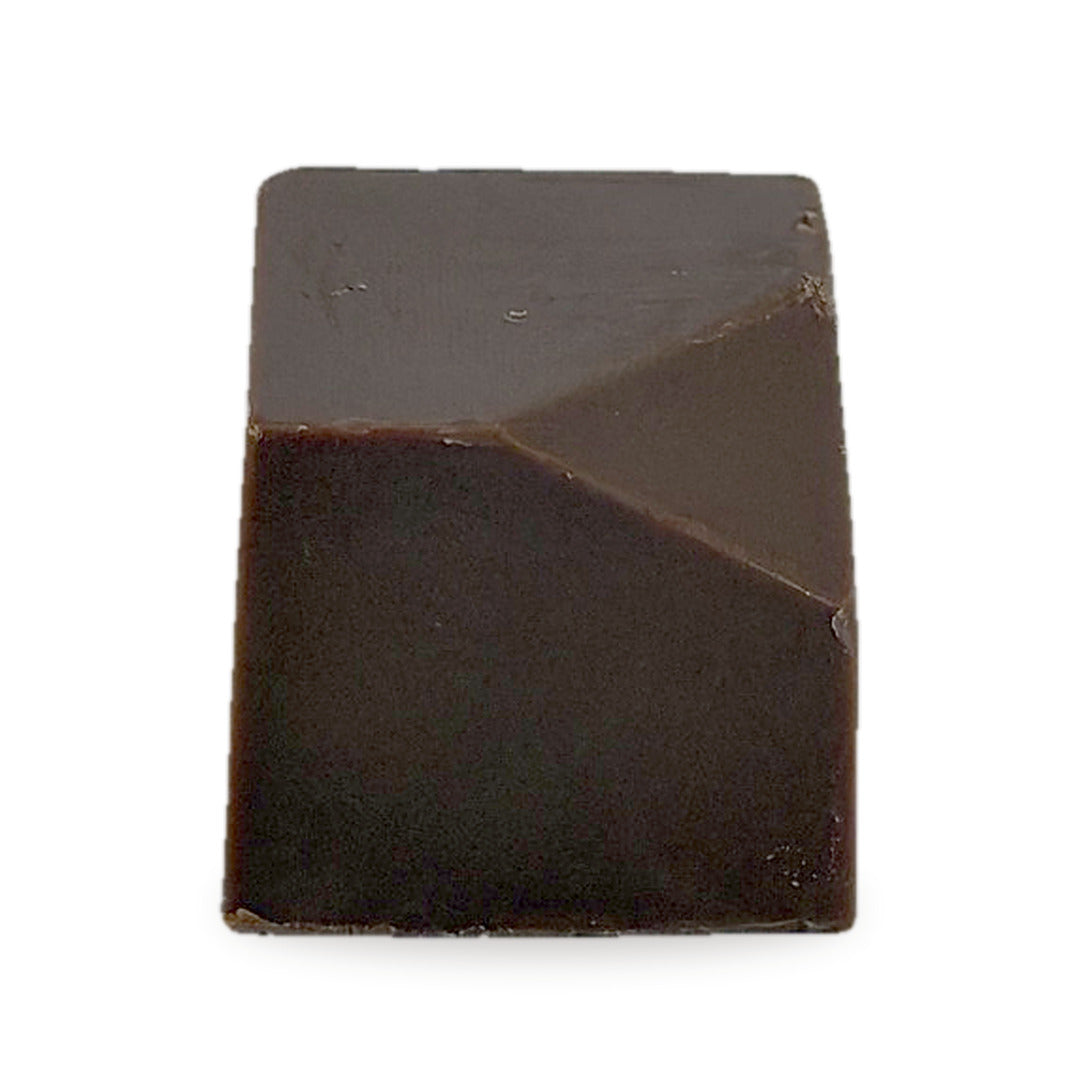 A whole Baklava Caramel — a milk chocolate cube with a faceted top