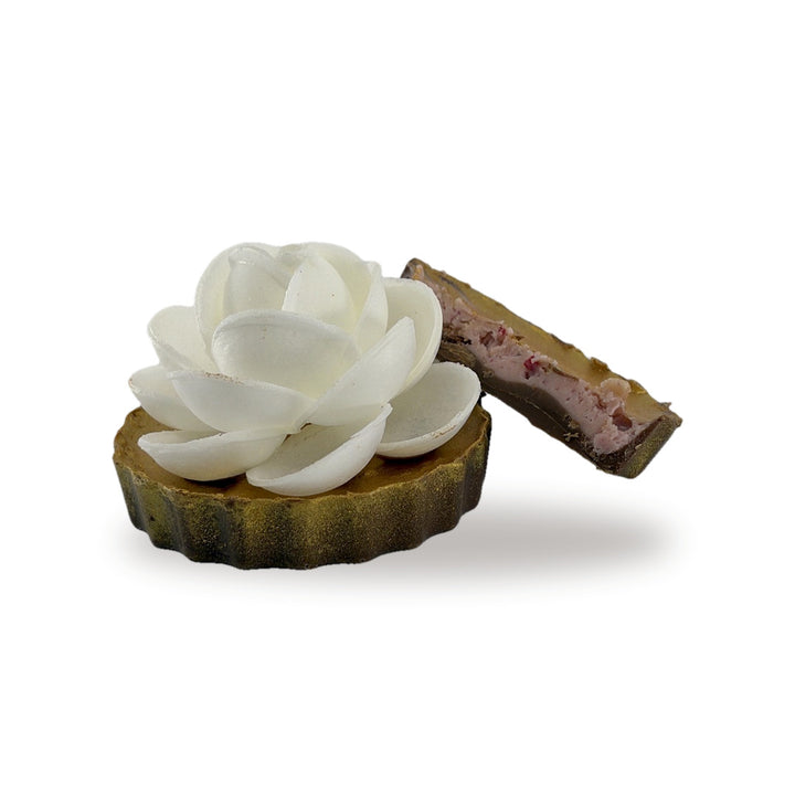 Flower Berry Rouge cut open, showing the raspberry and strawberry cream filling inside the milk chocolate