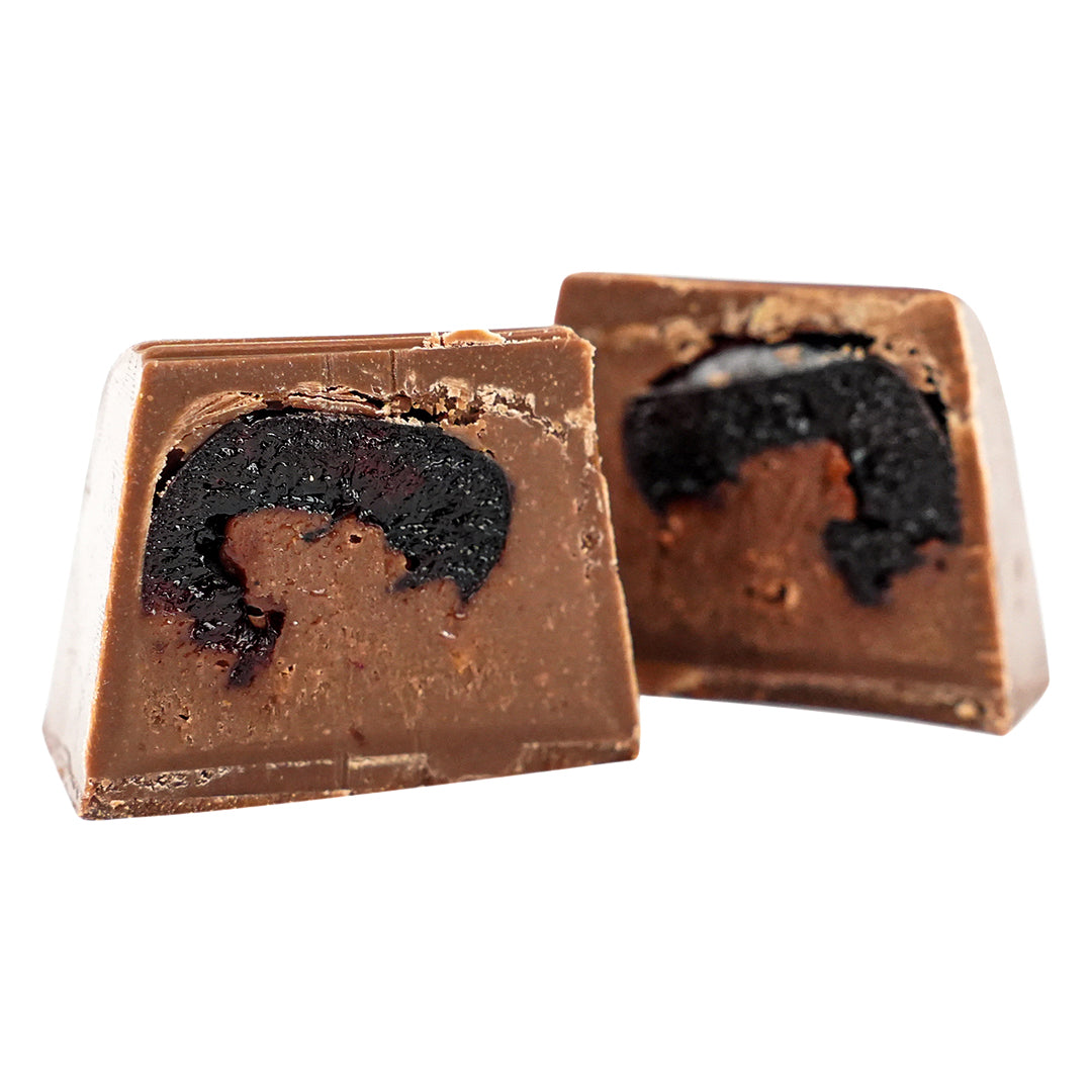 Milk chocolate square cut open showing rich blackberry filling inside.