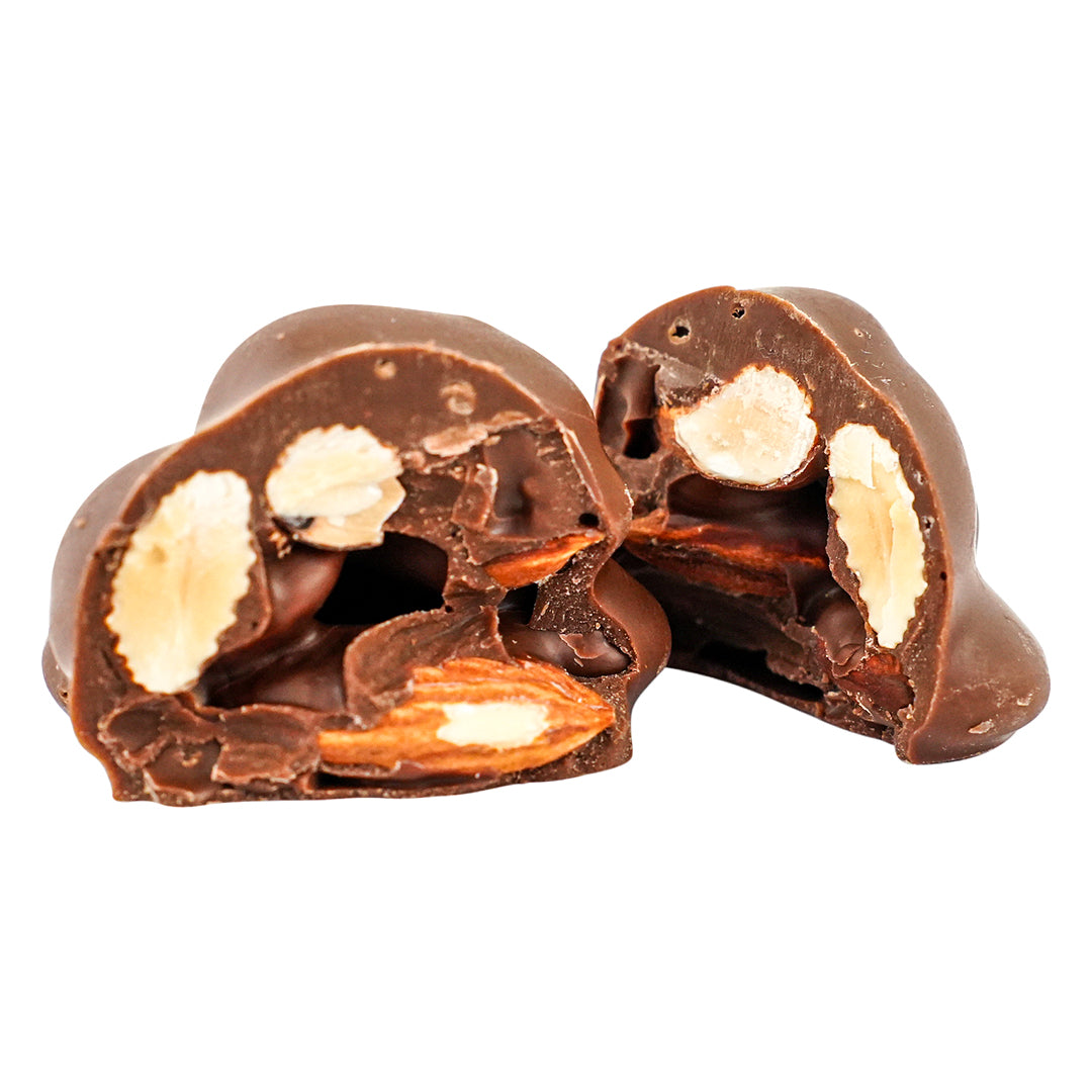Roche Almond cluster cut open showing crunchy whole almonds coated in milk chocolate.
