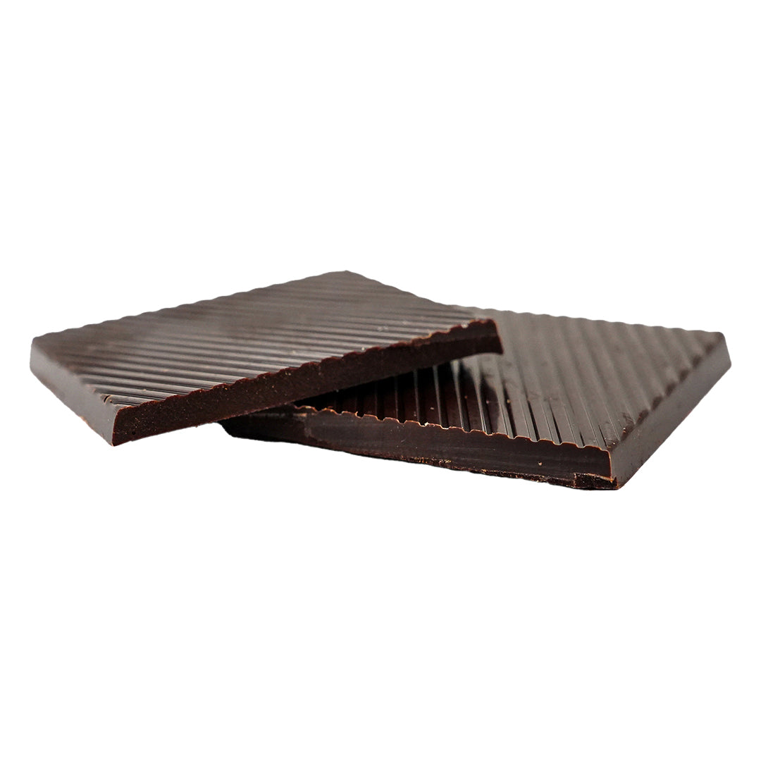 Thin rectangular dark chocolate bars stacked with textured lines.