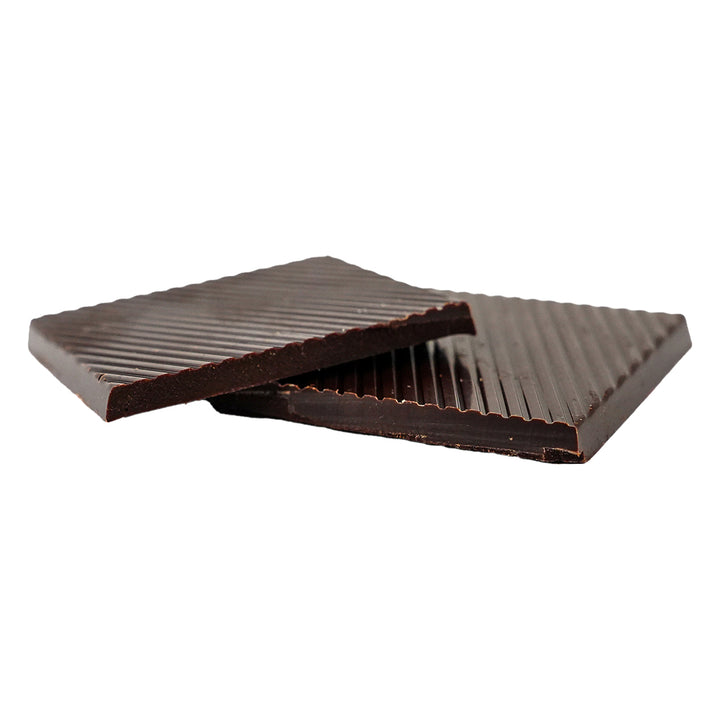 Thin rectangular dark chocolate bars stacked with textured lines.