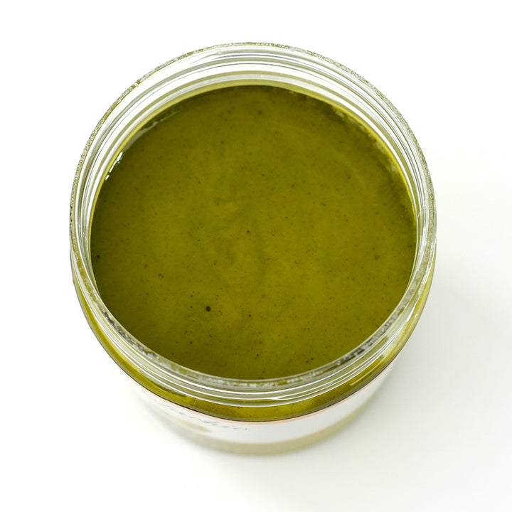 Open jar of Pistachio Butter showing smooth green spread inside.