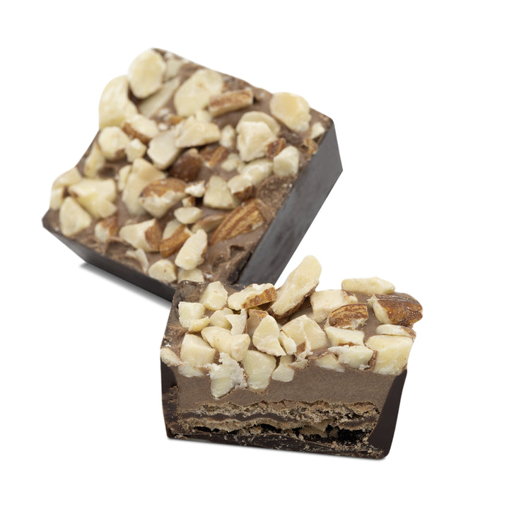 Cross-section showing biscuit base and nut topping coated in dark chocolate