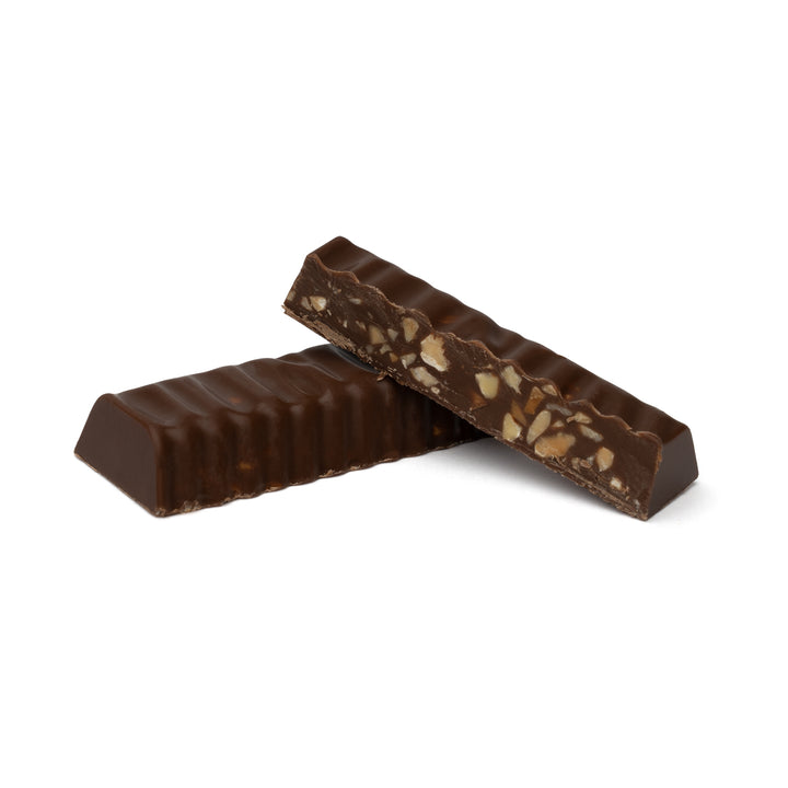 Long milk chocolate bar with chopped nut filling exposed
