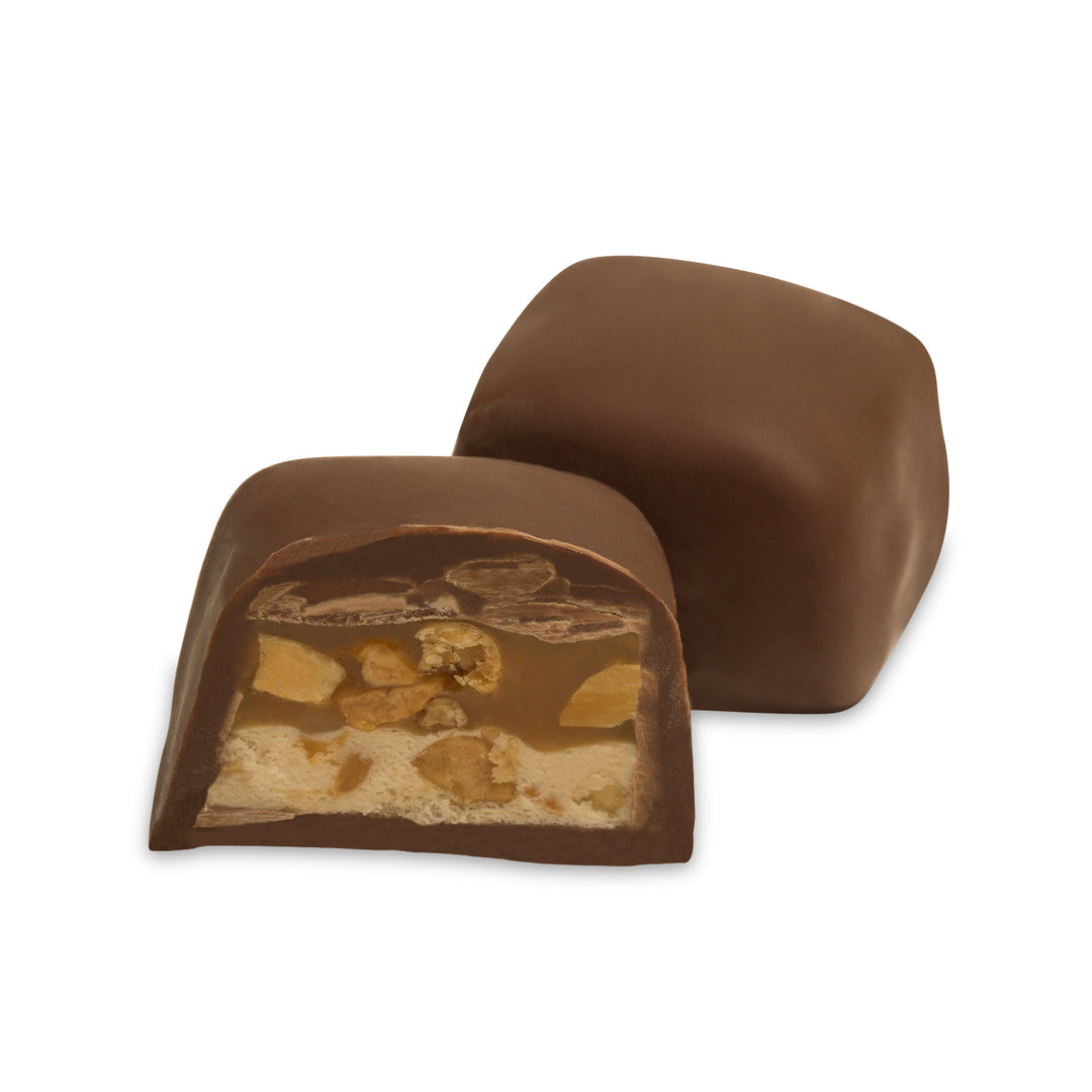 Cross-section showing nougat, caramel, and peanuts inside chocolate shell